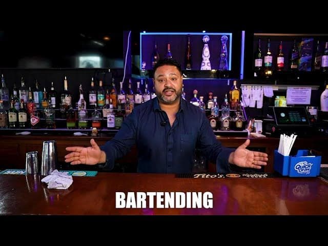 Instructor behind the bar at Famous Bartending School — play the training video